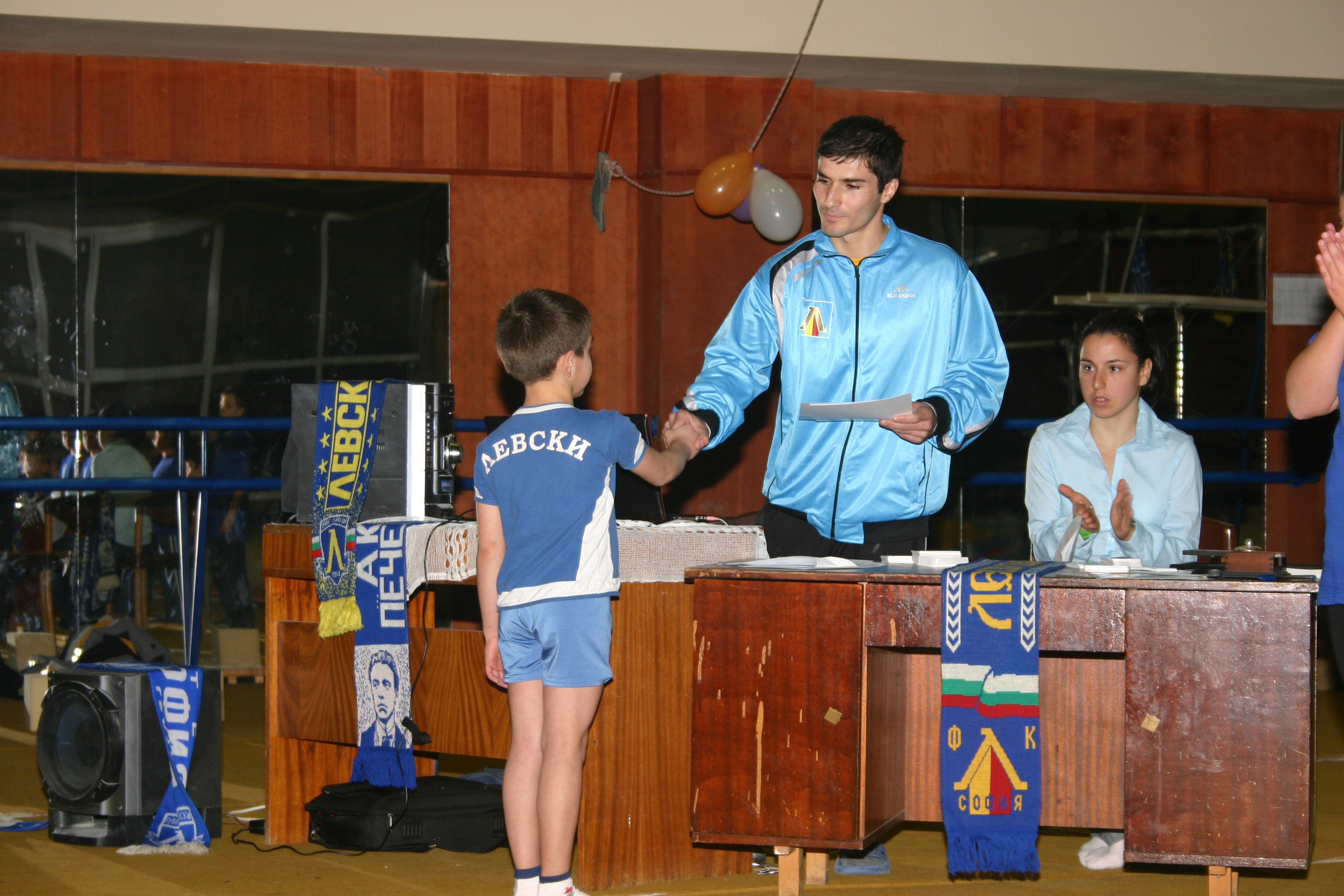 coach Stefan awarding certificates to his gymnasts