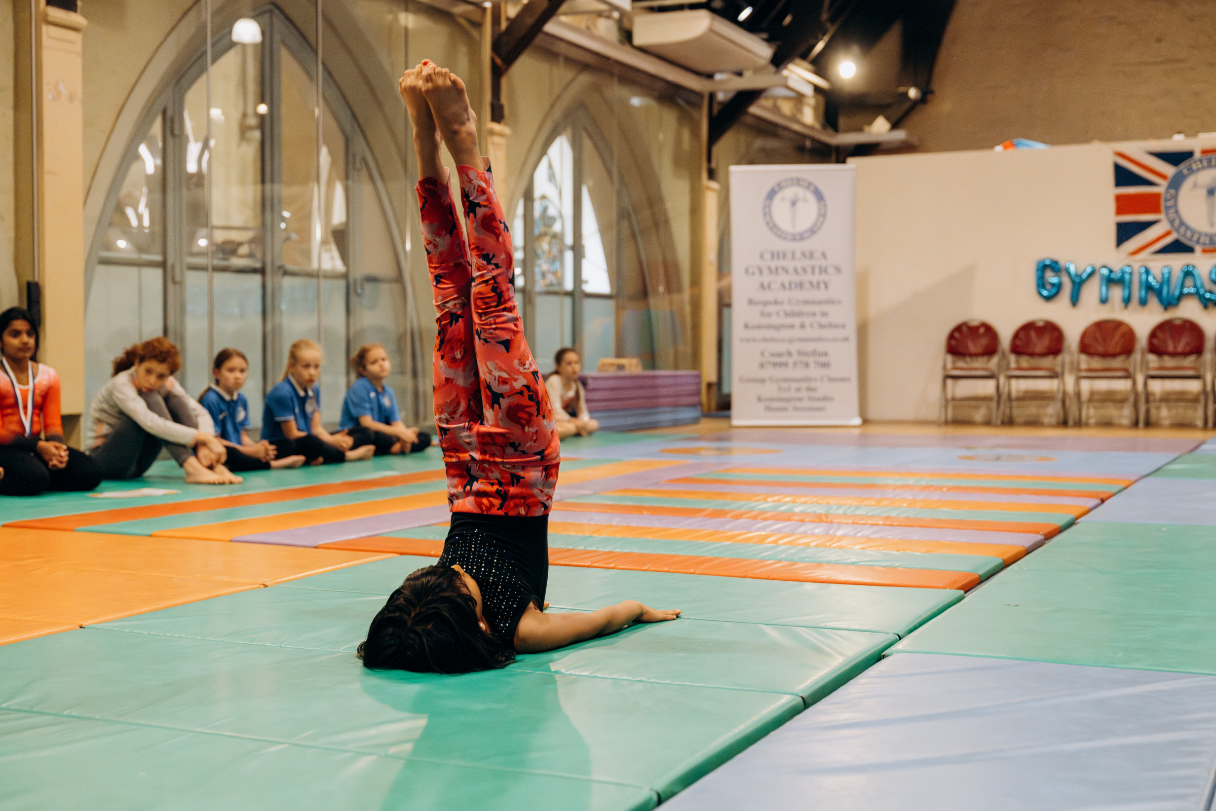 Shoulder stand in gymnastics at Chelsea Gymnastics Academy in London